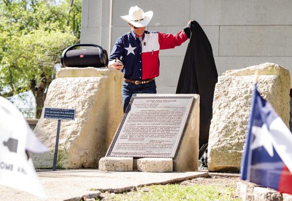 Doc Collins, the Van Zandt County Chairman for The Alamo Letter Society, unveiled a 200-pound bronze plaque in recognition of the 220-word ‘Victory or Death’ Letter that was dedicated April 12 on the northside steps of the VZC Courthouse. VZC was the fourth county in the state to receive the plaque from The Alamo Letter Society, who is attempting to place the plaque in all 254 courthouses throughout the state. Photo by Faith Caughron