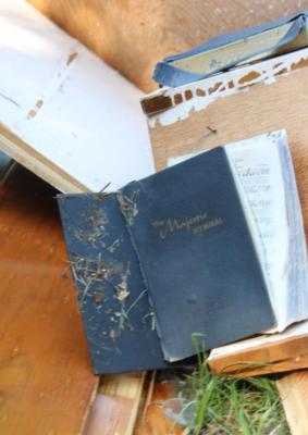 Left, a back view of the damage to the chapel. Above, a hymnal outside of Wesley Chapel Cemetery. Photos by Britne Hammons