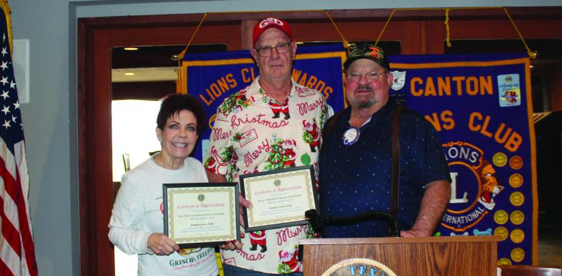 Following his presentation at the Canton Lions Club weekly luncheon Dec. 17, Jerry Tidwell (middle), manager of the Manna Food Bank, received a ‘Certificate of Appreciation’ from Canton Lions Club President Sandy Sims. Photo by Susan Harris