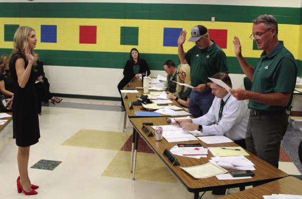 Canton ISD Secretary to the Superintendent Stacie Wilkerson administered the oath of office May 13 to trustees Matthew Dunn (Place 1), far right, and Board President Kenneth Pruitt (Place 2) during the regular monthly meeting of the Canton School Board. Dunn and Pruitt were the only candidates to sign up for the positions and as a result, the May 4 school board election was cancelled. Photo by David Barber