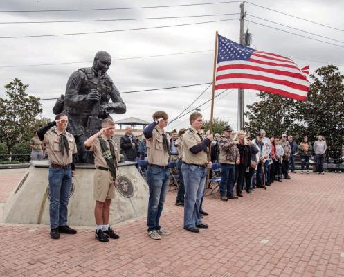 Members of Boy Scout Troop 378 stand at attention during the National Anthem at the beginning of the annual Veterans Day ceremony Nov. 11 at the Van Zandt County Veterans Memorial in Canton. The keynote speaker was Master Sgt. Dan Curtis U.S. Army Ret. who also serves as the VZC Veterans Memorial Board secretary.  Photo by Faith Caughron