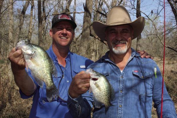 Guide Chris Webb, left, and Kenneth Shepherd show off some nice crappie landed from a backwoods creek recently. Spawning crappie have moved into the creeks above reservoirs and catching should remain good for a few more weeks. Photo by Luke Clayton