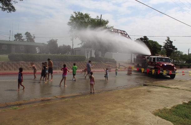 A ‘Splash Day’ event sponsored by Canton Main Street was held across the street from Canton City Hall Aug. 10. The event drew a large number of kids which featured water slides, face painting, and carriage rides. One of the biggest attractions was the arrival of a Canton Fire Department truck that sprayed water on the kids on a warm weather day. Photo by David Barber