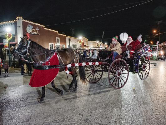 One of the featured attractions during the annual Canton Texas Chamber of Commerce Christmas Parade Dec. 9 was the arrival of Santa Claus as he joined the parade route through the downtown square in a horse-drawn carriage. A record 73 entries were in the parade as a good crowd was on hand to enjoy the parade and the Snow Day Festival activities throughout the cool, windy evening. Additional photos on 12A.