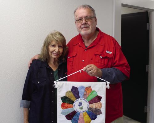 Texas Star Quilters Guild, Van Zandt County, Publicist Janet Bragdon presented a 2025 TSQG Sponsor Quilt recently to Van Zandt Newspapers LLC Editor David Barber. The annual TSQG event was held Nov. 7, 8 at the Parish Hall at St. Therese Catholic Church in Canton. Barber served as one of the quilt judges for the event. Photo by Tim Ball