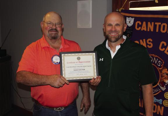 Following the conclusion of the weekly Canton Lions Club Luncheon Oct. 15, a ‘Certificate of Appreciation’ was presented by Canton Lions Club President Sandy Sims, left, to Canton High School Athletic Director and Head Football Coach Heath Ragle. Story on 5A. Photo by David Barber