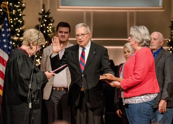 New Van Zandt County Judge Andy Reese was sworn into office Jan. 1 by former VZC District Judge Teresa Drum during a swearing-in ceremony for 16 newly elected VZC officials at Lakeside Baptist Church in Canton. Standing with Reese were his wife, Lori, and son, Harry. Photo by Faith Caughron