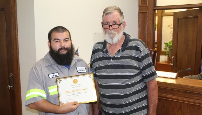 Van Zandt County Pct. 3 Employee Dalton Stringer, left, was recognized for his five years of service to VZC by VZC Pct. 3 Commissioner Bobby Phillips during the regular meeting of the VZC Commissioners Court May 21. Photo by David Barber