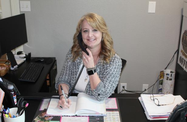 New Canton Texas Chamber of Commerce Administrator Kelli Ridgway answers a question on the phone during a busy workday. The chamber office recently moved into a new location at 1040 South Trades Day Blvd. (State Highway 19) in Canton. Photo by David Barber