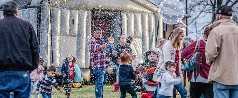 Attendees at last year’s Snow Day Festival sponsored by the Canton Texas Chamber of Commerce and the Canton Main Street Program enjoyed playing in the snow and bouncing in the bounce house. Photo by Faith Caughron