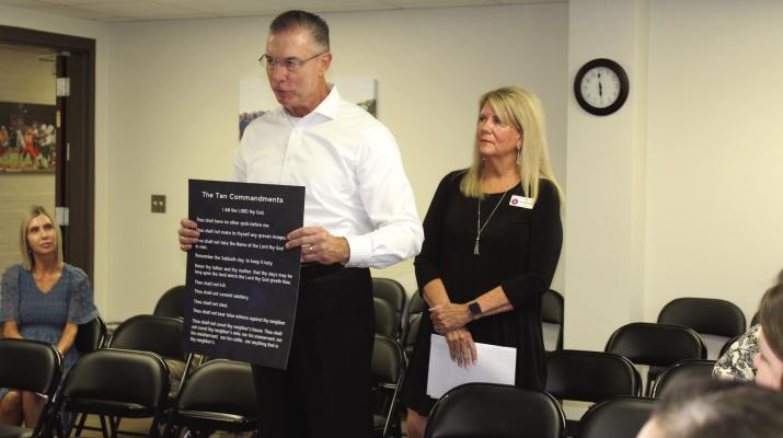 Tom and Suzanne Duke, representing the Republican Club of Van Zandt County, presented copies of the Ten Commandments during the regular monthly meeting of the Canton School Board Aug. 18. Copies of the 10 Commandments were presented during every school board meeting in VZC during the month of August. Photo by Susan Harris