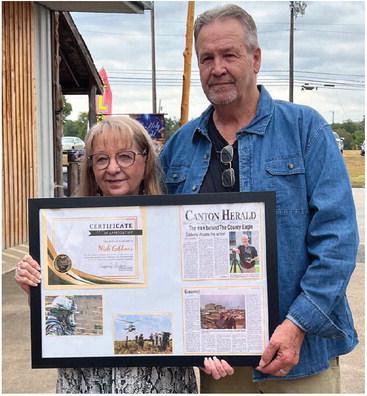 A reception was held Sept. 15 to recognize The County Eagle Owner and Editor Nick Gibbons and his wife, Val, for their work in the community. The Gibbons are holding a framed copy of an article on Gibbons that was printed in the Canton Herald as well as a ‘Certificate of Appreciation’ that was presented by Van Zandt Newspapers L.L.C. General Manager Tiffany Hardy. Additional photos on 8A. Photo by Tiffany Hardy