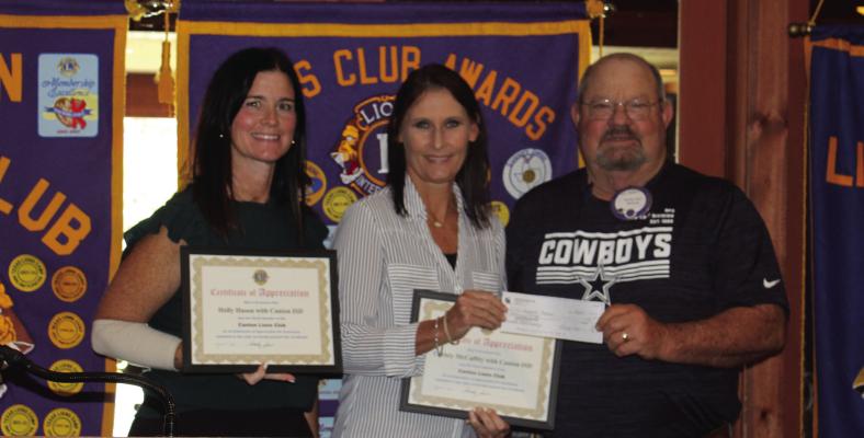 Following their presentation on the Canton ISD Backpack Program Aug. 27, community volunteers Christian Mc-Caffy and Holly Hewson were presented with ‘Certificates of Appreciation’ by Canton Lions Club President Sandy Sims. The Canton Lions Club Luncheon was held at the Van Zandt Country Club. Photo by Susan Harris