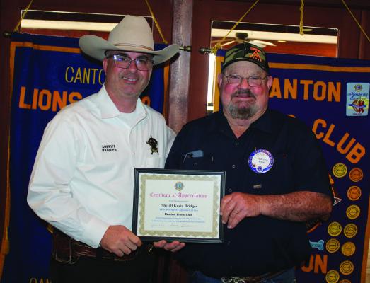 A ‘Certificate of Appreciation’ was presented to Van Zandt County Sheriff Kevin Bridger, left, following his speech at the weekly Canton Lions Club Luncheon held at the Van Zandt Country Club Feb. 18. Presenting the certificate to Bridger was Canton Lions Club President Sandy Sims. Photo by David Barber