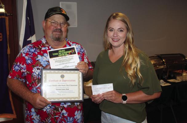 Project Canton ISD ‘Stock the Classrooms’ Founder Lacye Welch received a ‘Certificate of Appreciation’ from Canton Lions Club President Sandy Sims following Welch’s presentation July 16 during the weekly club luncheon at Van Zandt Country Club. Sims also presented Welch with a donation check of $1,000.00 from the Canton Lions Club to ‘Stock the Classrooms.’ Photo by David Barber