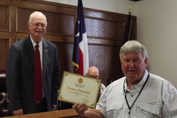 Van Zandt County Treasurer Kenny Edwards (right) was recognized for his 15 years of service to VZC by the VZC Commissioners Court during its regular meeting May 10. Presenting the ‘Certificate of Appreciation’ to Edwards was VZC Pct. 2 Commissioner Virgil Melton Jr., who was presiding over the meeting in the absence of VZC Judge Andy Reese, who was out of town at a mandatory training seminar. Photo by David Barber