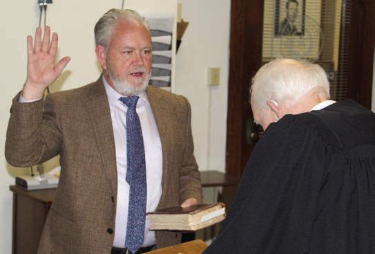 Newly appointed Van Zandt County Pct. 2 Commissioner Cliff Williams takes the oath of office Aug. 23. The oath of office was administered by Judge Bill Bass of Tyler, a personal friend of Williams. Photo by David Barber