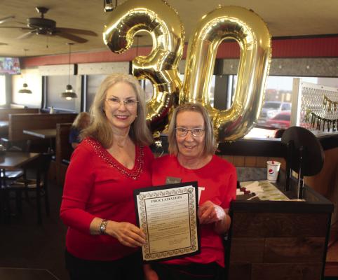 Canton Mayor Lou Ann Everett, left, proclaimed Monday, Feb. 3 as ‘Dorothy Baker Day’ in Canton. Baker, right, was recognized for her 30 years of service at Pizza Hut in Canton as she was presented with a proclamation read by Everett. Among those in attendance for the surprise announcement for Baker were Everett, Canton Police Chief Brad Allison, Canton Fire Chief Bud Sanford, Canton City Manager Lonny Cluck, and Canton Assistant City Manager Steve Ruppenthal. Photo by David Barber