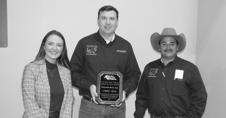 Joseph Grier, center, was recognized with a ‘Distinguished Service Award’ Nov. 2 during the annual Van Zandt County Hay Evaluation Clinic and Auction at the VZC Farm Bureau building in Canton. The award was presented by Allison Morrow from the VZC Texas A&amp;M AgriLife Extension Service office and Gregg Beverly from the VZC Livestock/Forage Committee. Photo by david Barber
