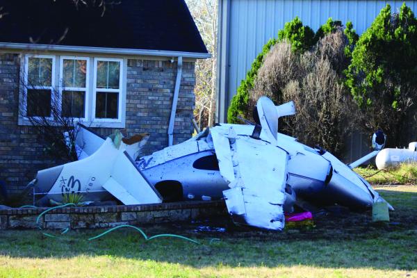 A civilian aircraft crashed in the area of Private Road 7005 in Edgewood on Dec. 26, 2003, at around 6 p.m. The plane came to rest, striking a residence at the location and causing minor damage to the home. Photo by Nick Gibbons, The County Eagle