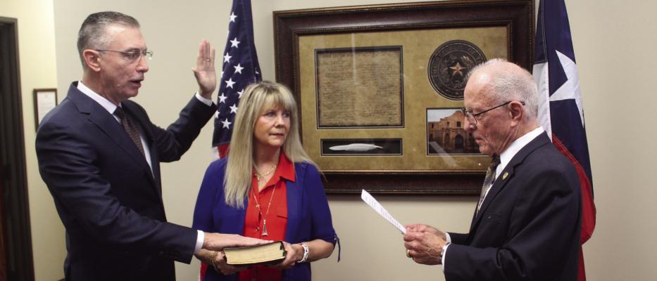 The Oath of Office was administered June 19 to new Van Zandt County Republican Party Chairman Tom Duke (left) as his wife, Suzanne, holds the Bible. Duke was administered the Oath of Office by Texas District 2 State Senator Bob Hall. The swearing-in ceremony was held in Hall’s Canton office. Photos by David Barber
