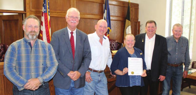 Carrie Woolverton of the Van Zandt County Historical Commission stood with the VZC Commissioners Court following unanimous approval by the court to recognize June 14 as Flag Day and the week of June 12 as Flag Week. Standing with Woolverton were left to right, VZC Pct. 1 Commissioner Chad LaPrade, VZC Pct. 2 Commissioner Virgil Melton Jr., VZC Pct. 3 Commissioner Keith Pearson, VZC Judge Don Kirkpatrick, and VZC Pct. 4 Commissioner Tim West. Photo by David Barber