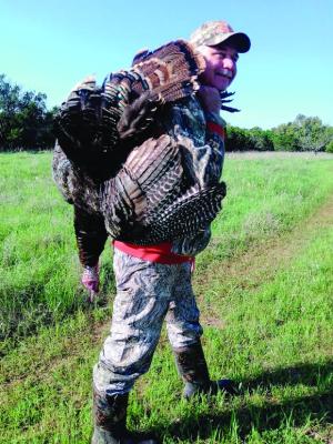 Jeff Rice packs his Thanksgiving turkey out of the woods. Photo by Luke Clayton