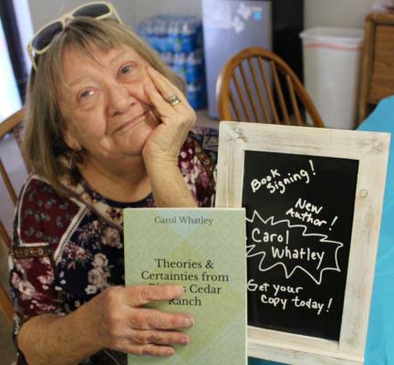 Carol with her newly published book in 2019. Photo by Britne Hammons