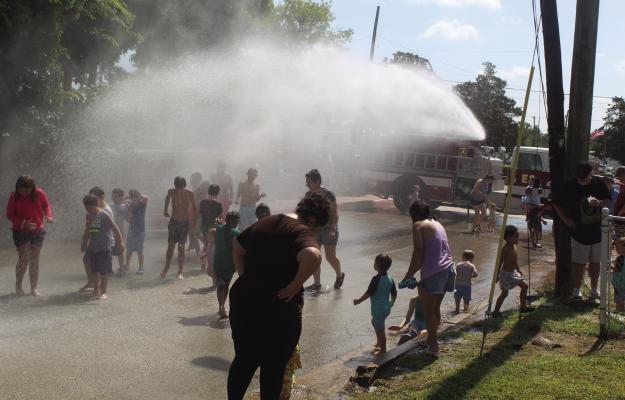 On a warm summer day July 19, kids enjoyed being sprayed with cold water courtesy of the Canton Fire Department during the Annual Kids’ Splash Day in front of Canton City Hall. There were a number of water slides and other events that took place to entertain the children as summer is winding down before school starts next month. Photo by David Barber