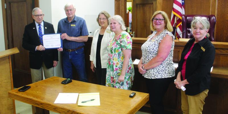 Every year since 2009, the Van Zandt County Historical Commission (VZCHC) has received a Distinguished Service Award from the Texas Historical Commission. The award for 2025 was presented to VZCHC President Elvis Allen, second from left, by VZC Judge Andy Reese, far left, during the regular meeting of the VZC Commissioners Court June 17. Standing with Allen and Reese were VZCHC Members, left to right, Sherrie Archer, Debra Johnson, Lisa Mays-Gonzalez, and Suzie Bass. Photos by David Barber