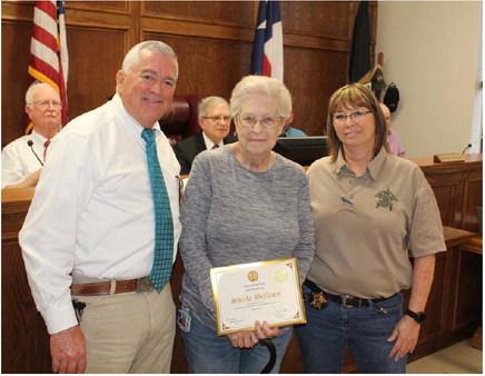 Sheila Bellamy (middle) was recognized for her 10 years of service to Van Zandt County March 1 during the regular meeting of the VZC Commissioners Court. Presenting Bellamy to those in attendance were VZC Sheriff Joe Carter and VZC Sheriff’s Department Captain Melonie Williams. Photos by David Barber