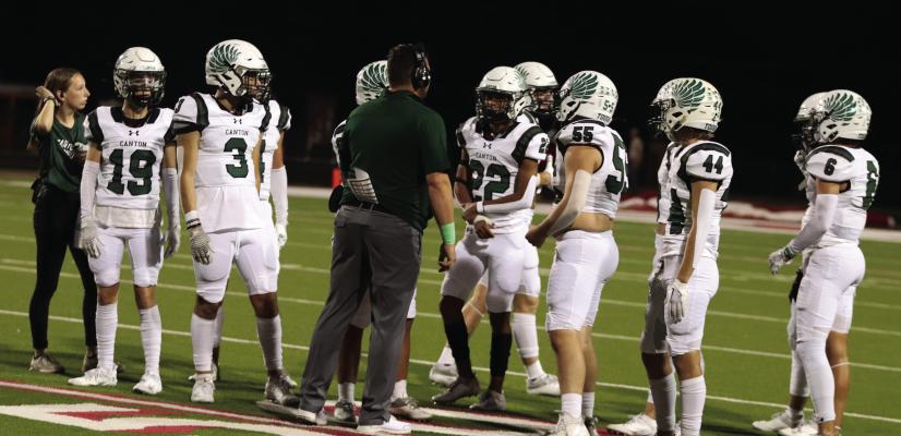 A Canton Eagle assistant coach visits with several players to discuss strategy during the Eagles’ varsity football game against the Van Vandals Sept. 29 in Van. After falling to the Vandals, the Eagles’ hope to get back on the winning track Oct. 6 when they host the defending Class 4A state champion and current number one ranked team in the state, the Carthage Bulldogs, in a 7:30 p.m. kickoff. Photo by Lianna Reid