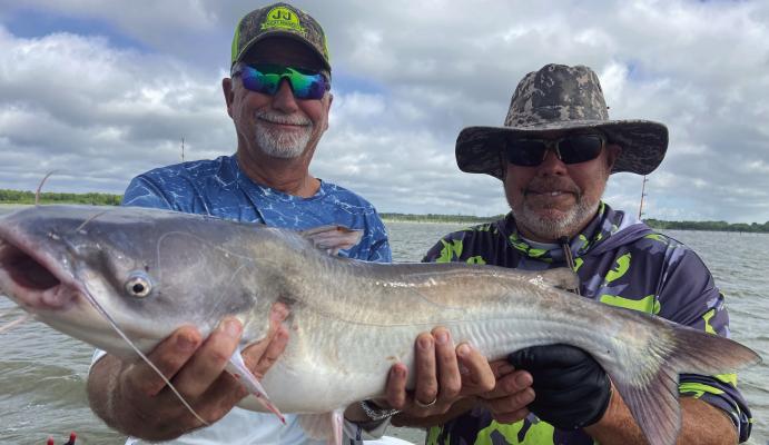 Jeff Rice, left, and Tawakoni catfish guide Tony Pennebaker show off one of many good eating blue catfish landed last week. Photo by Luke Clayton