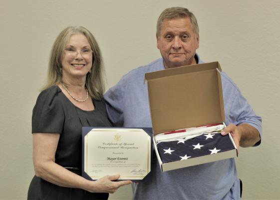 Canton Mayor Lou Ann Everett poses with City Manager Lonny Cluck to present a flag gifted to city employees by congressman Lance Gooden Photo by Ethan Adams