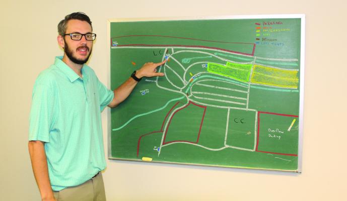 Tailwind Regional Balloon Festival Coordinator Austin Melton discusses the location of the information booth leading up to the festival on July 7, 8. Around 30 balloonists are scheduled to participate. The anticipated crowd is expected to be 5,000-10,000 people each evening during the festival. Photo by David Barber