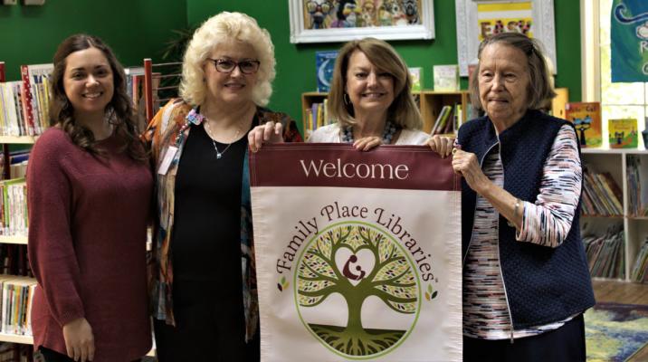 Kathy Deerr presented the Van Zandt County Library with their official Family Place Library banner following her presentation on Thursday, Sept. 15. Accepting the award on the library’s behalf was Jordin Shilling, Tonja Garten, and Sarah Norman. Photo by Ethan Adams