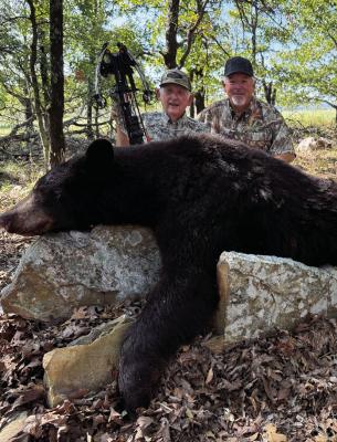 David Cotton, left, and his Dad, Edgar, show one of two black bears taken last week in Southeast Oklahoma at the Choctaw Hunting Lodge. Photo by Luke Clayton