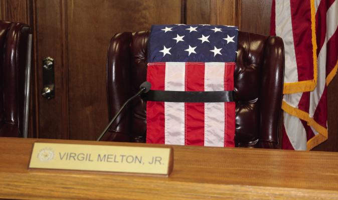 In memory of Van Zandt County Pct. 2 Commissioner Virgil Melton Jr., an American flag was placed over his chair in the commissioners’ courtroom prior to the beginning of the June 5 regular meeting of the commissioners’ court. Photo by David Barber