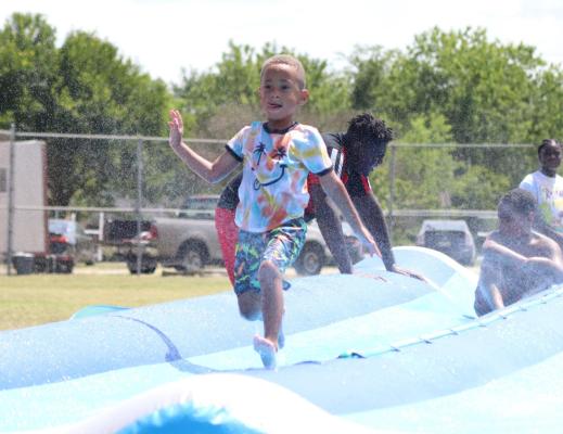 Inflatable rides filled with water helped to keep kids cool during this year’s Juneteenth celebration event at South Park. Photo by David Kapitan