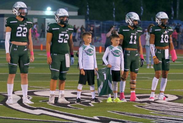 Two of Wyatt Brey’s teammates joined the Canton captains at midfield for the coin toss before Friday night’s game vs. Van. Photo by Cori Edelmon Smith