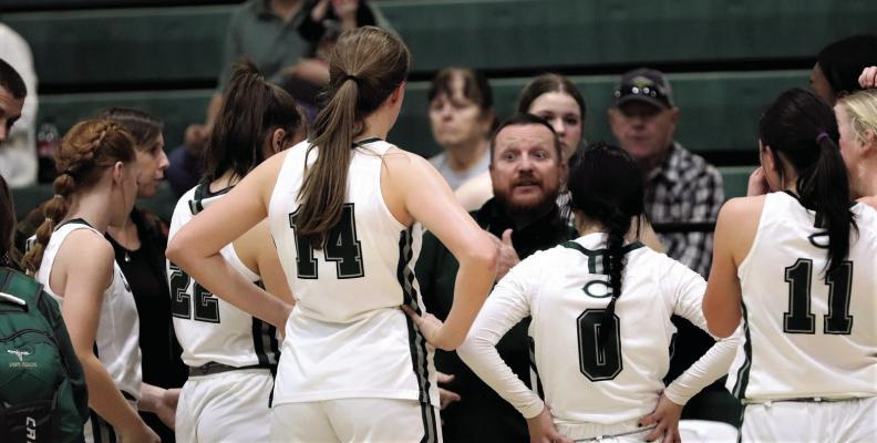 Head Coach Troy Carrell talks to his team during a timeout in Canton’s one-point victory over Mabank on Friday night. Photo by Lianna Reid