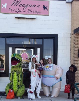 Megan’s Pet Spa and Boutique owner Megan Lanham, middle, celebrated Halloween with her family one day prior to opening her downtown Canton business. Courtesy photo