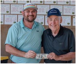 Michael Maxfi eld took home $100 for winning the closest to the pin competition at the VZ Veterans Memorial Golf Tournament. He was awarded his prize by Cary Hilliard. Photo by Faith Caughron