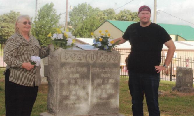 Mrs. Maloney and her son, Mark, stand at the grave of her ancestors, Dr. James Matthew and his wife, Georgia. Courtesy photo