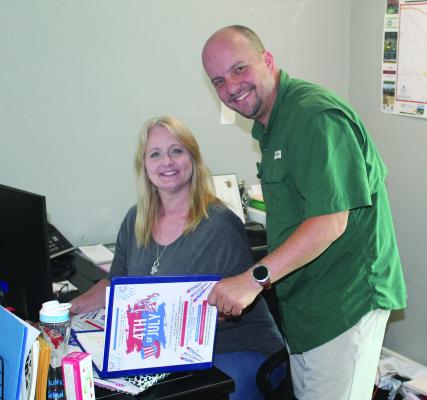 Canton Texas Chamber of Commerce Board Vice-Chairman Blake Fowler and Chamber administrator Kelli Ridgway prepare to go over the schedule of activities for the upcoming Fourth of July celebration in downtown Canton. For more information, call the chamber office at 903-567-2991 or visit www.cantontexaschamber.com. Courtesy photo