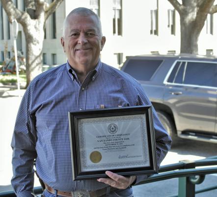 Van Zandt County Sheriff Joe Carter holds the ‘Certificate of Compliance’ recently awarded to the VZC Jail by the Texas Commission on Jail Standards. VZC Judge Don Kirkpatrick announced the accomplishment during the regular meeting of the VZC Commissioners Court Oct. 26. Photo by Ethan Adams