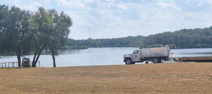 Following the placement of a sign last week at the Mill Creek Reservoir in Canton prohibiting swimming between the boat docks, work has begun on creating a specified swim area, with a beach, for families to enjoy swimming without being in the restricted areas. Photo by Don Johnson