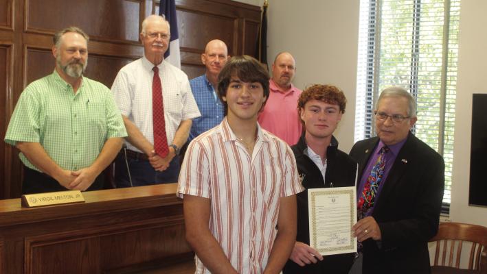 During their regular meeting Sept. 27, Van Zandt County Judge Andy Reese and the VZC Commissioners Court recognized Wills Point High School seniors Yuri Frykholm (left in the front row) and Kyle Etheridge for their recent act of bravery. Standing in the back row, were left to right, VZC Commissioners Chad LaPrade (Pct. 1), Virgil Melton Jr. (Pct. 2), Keith Pearson (Pct. 3), and Brandon Barton (Pct. 4). Photo by David Barber