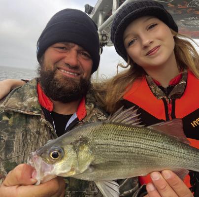 Guide Brandon Sargent with his little “Deck Hand” daughter Brooklyn who is not only cute as a button but also a very experienced angler for someone of her tender years. Photo by Luke Clayton