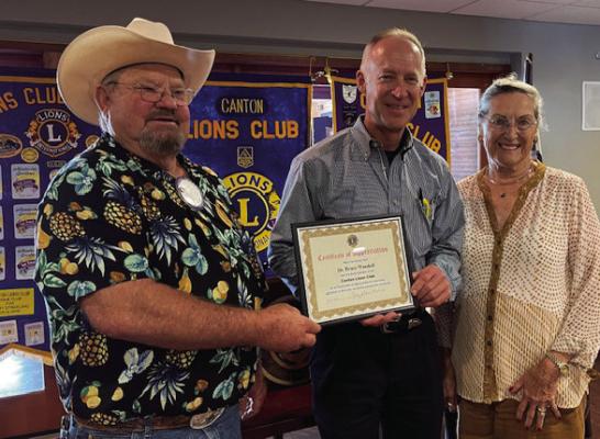 A ‘Certificate of Appreciation’ was presented to Dr. Bruce Woodall, middle, following his presentation about the Free Burma Rangers July 10 at the weekly Canton Lions Club Luncheon at the Van Zandt Country Club in Canton. Presenting the certificate were Canton Lions Club Vice-President Sandy Sims and Canton Lions Club member Anna McDaniel. Courtesy photo